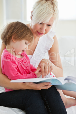 Young family reading a book