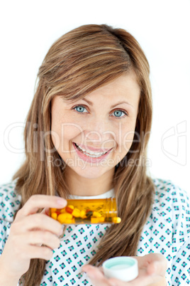 Smiling young woman taking pills