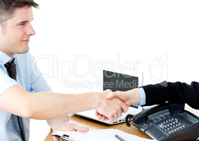 Assertive businesswoman shaking hands with a female customer