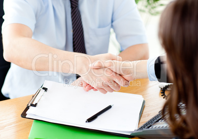 Close up of concluding a contract between businessman and woman