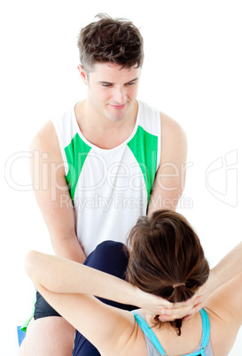 Attractive man doing fitness exercises with a woman