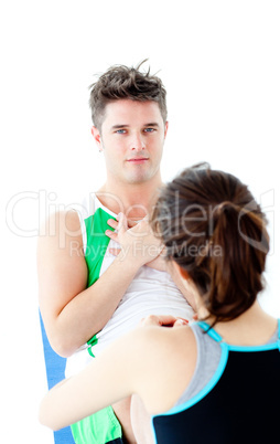 Muscular man doing fitness exercises with a woman