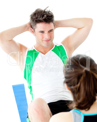 Handsome man doing fitness exercises with a woman