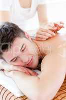 Charming young man in an acupuncture therapy in a Spa center