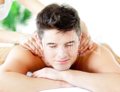 Handsome caucasian man having a back massage