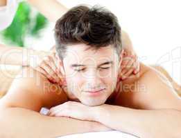 Handsome caucasian man having a back massage