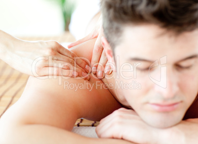 Relaxed young man having a back massage