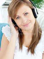 Portrait of a delighted woman listen to music with headphones
