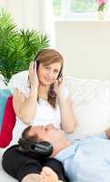Charming caucasian couple listen to music wearing headphones