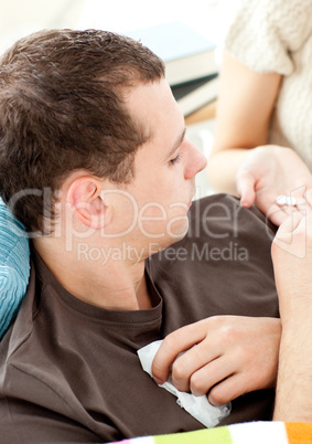 Close-up of a sick man taking pills from his girlfriend