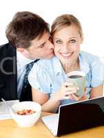 Attractive  businessman kissing his girlfriend while having brea