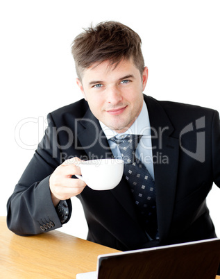 Charming young businessman holding a cup smiling at the camera