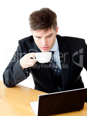 Stressed young businesswoman drinking coffee and using his lapto