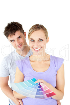 Affectionate young couple choosing colors for painting their roo