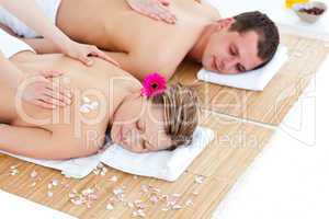 Beautiful young couple receiving a back massage