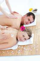 Enamoured caucasian couple having a back massage