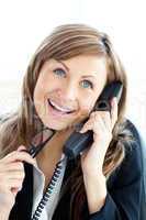 Confident young businesswoman talking on phone sitting