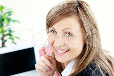 Radiant young businesswoman wearing headphones