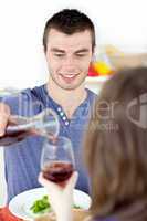 Attractive man having dinner with his girlfriend drinking wine