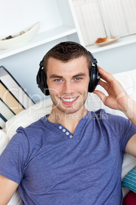 Smiing caucasian man listen to music with headphones