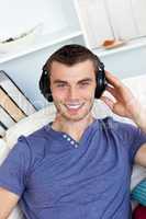 Smiing caucasian man listen to music with headphones