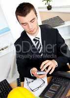 Confident businessman using his calculator
