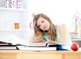 Stressed young woman studying in her kitchen