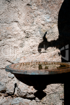 Shadow of an olld water pump