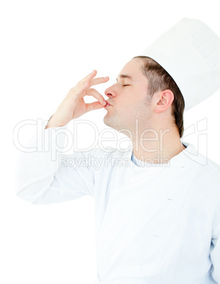 Serious male cook showing the sign for delicious