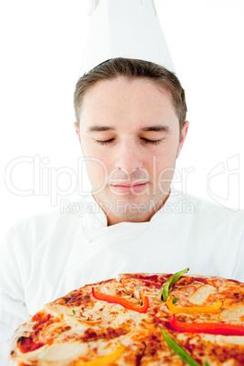 Young male cook smell at pizza with closed eyes