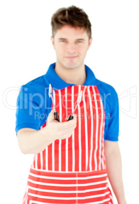 Handsome young cook holding a cookware