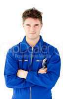 Charismatic mechanic holding tool smiling at the camera