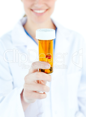 Close-up of blond caucasian doctor holding pills in the camera