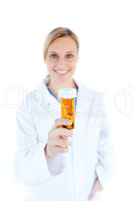 Portrait of caucasian doctor holding pills in the camera