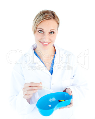 Charismatic female doctor holding capsule