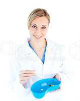 Charismatic female doctor holding capsule