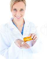 Charming young doctor holding pills