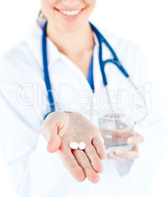 Close-up of caucasian doctor holding pills and water