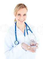 Pretty female doctor holding pills and water