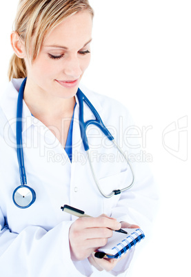 Concentrated female doctor taking notes on her notepad