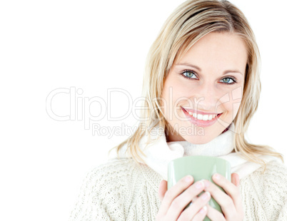 Relaxed woman holding a cup of coffee standing