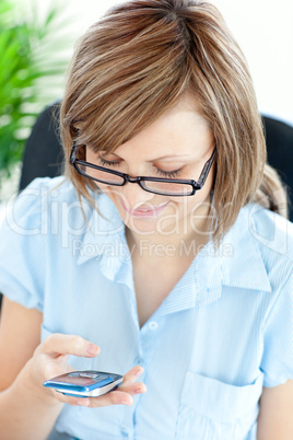 Positive young businesswoman texting