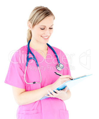 Ambitious female surgeon writing on a clipboard