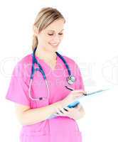 Ambitious female surgeon writing on a clipboard