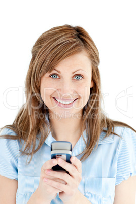 Positive businesswoman texting smiling at the camera