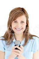 Positive businesswoman texting smiling at the camera