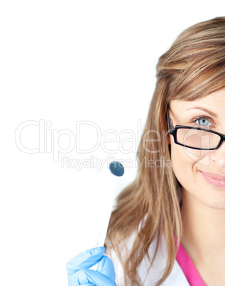 Confident female dental surgeon holding  a speculum