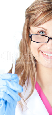 Charming female dental surgeon holding  a speculum