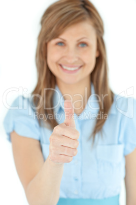 Radiant businesswoman smiling at the camera with thumb up