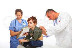 Doctor and Nurse examining a boy